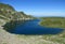 Rila mountains in Bulgaria, deep blue lakes and gray rock summit during the sunny day with clear blue sky