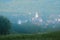 Rimetea village in Transylvania, Romania during a foggy sunrise, as seen from an elevated location on the nearby hill