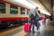 Rimini, Italy - 13.05.2018: Couple parting and kissing on platform of railway station in Rimini, Italy