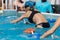 Rimini, Italy - may 2019: Girl Doing Water Exercises with Bike Outdoor in a Swimming Pool