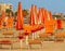 Rimini - Orange beach umbrellas and sunbeds
