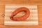 Ring of boiled-smoked sausage on the cutting board