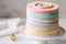 ring cake made using a stack of colorful and playful marble or pastel cake layers