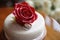 ring cake with a single delicate rose on top