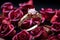 Ring of love engagement ring elegantly situated among scattered rose petals