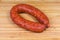 Ring pork bologna sausage on a wooden cutting board