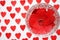 Ring on red hearts in a crystal glass on a white background with hearts