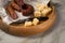 Ring Salami pork sausage with German BierbeiÃŸer and Edamer cheese in wax paper with knife on wooden board background for Brotzeit