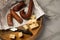 Ring Salami pork sausage with German BierbeiÃŸer and Edamer cheese in wax paper with knife on wooden board background for Brotzeit