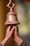 Ringing buddhist bell in nepali temple