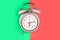 Ringing twin bell vintage classic alarm clock Isolated on red and green pastel colorful trendy background