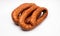 Rings of country style smoked sausage, isolated on a white background. Traditional Polish meat sausage, packshot photo.