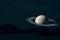 rings and saturn planet over island on the sea in night sky