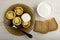 Rings of squash with forcemeat and cheese, sour cream, fork in plate, bowl with sour cream, slices of bread on table. Top view