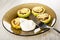 Rings of squash with forcemeat and cheese, sour cream in plate, fork on wooden table