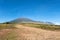 Rinjani mountain and savannah field with blue clear sky