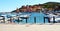 Rio Marina port town, bridge, rock, waves and boats in Tuscany, in Elba island, Italy