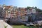 RIOMAGGIORE, ITALY - JULY 20, 2021: colorful houses overhanging cliffs in the National Park of Cinque Terre, Liguria, Italy