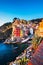 Riomaggiore town, cape and sea landscape at sunset. Cinque Terre, Liguria, Italy