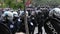 Riot officers stand by with automatic fire weapon and gas masks