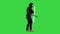 Riot policeman hitting shield with the baton while walking on a Green Screen, Chroma Key.