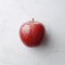 Ripe apple on an original red background