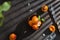 Ripe apricots, apricot leaves and a knife on dark concrete background. Top view, copy space. Organic fruits. Cookbook recipe