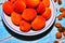 Ripe apricots in a bowl with stones