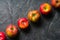 Ripe autumn apples red and yellow on a black stone background from slate. Harvesting. Vitamins are good for health.