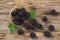 Ripe blackberries with leaves in wooden bowl on rustic wooden background