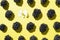 Ripe blackberry pattern on yellow background. Blackberries with white flower texture