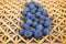 Ripe blueberries on straw mat.
