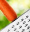 Ripe carrot rubbing on a grater