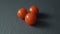 Ripe cherry tomatoes close-up on a stone gray dark background.