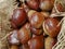 Ripe Chestnuts in the jute hessian sack bag on the market`s disp