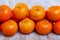Ripe clementines on wooden table in kitchen