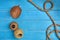 Ripe coconut, two skeins of jute twine or thread and a rope on blue wooden background or desktop. Close up, copy space