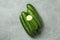 Ripe cucumbers on gray background, top view