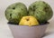 Ripe custard apples and quince on a rustic plate