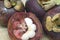 Ripe delicious mangosteen whole fruits and sliced on patch of hemp bag close up photo