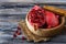 Ripe dissected pomegranate in wooden bowl