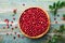 Ripe fresh cowberry lingonberry, partridgeberry, foxberry in wooden bowl on rustic vintage table from above.