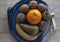 Ripe fresh fruits arranged on a decorative ceramic platter.