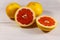 Ripe fresh grapefruits on white wooden table