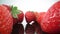 Ripe, fresh, natural strawberries in reflection, in extreme macro, close up. Movement forward, backward.