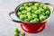 Ripe fresh organic gooseberry berry in red colander