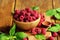 Ripe fresh raspberry in wooden bowl.