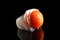 Ripe frozen tomato on dark table