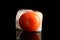 Ripe frozen tomato on dark table