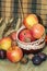 Ripe fruits, apples, plums, nuts in a bowl on the table, rustic style. Autumn harvest concept